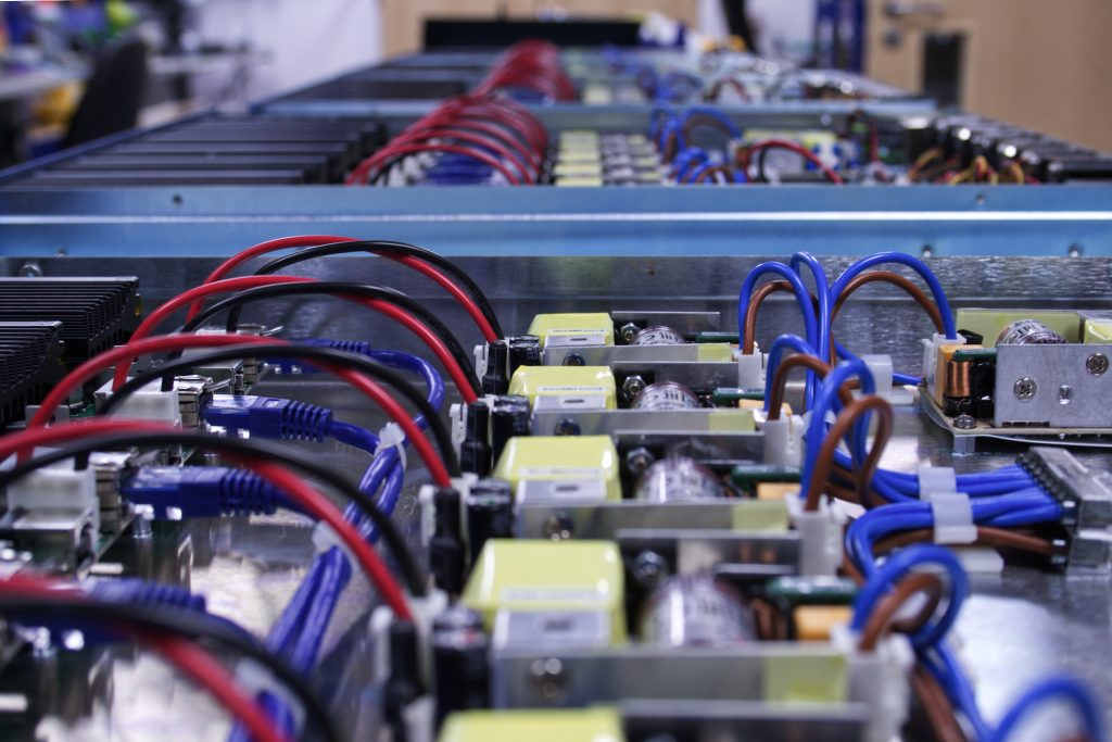 6-way Programmable Power Modules lined up mid-build so you can see inside the product